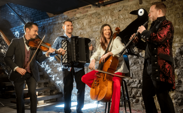 Quartetto Gelato play their instruments on stage in snazzy clothes