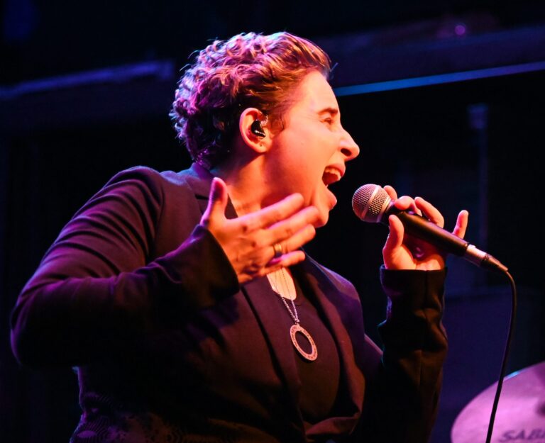Susana Williams singing at a microphone