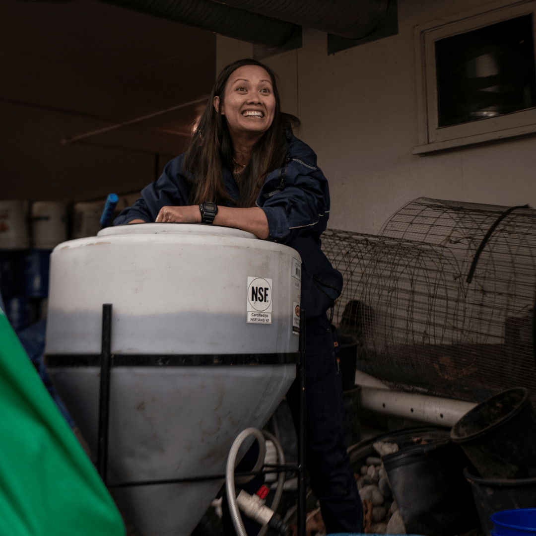 Jo Tobias poses with a large bin of soil