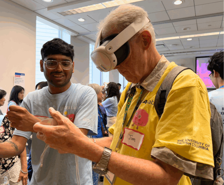 A male-presenting senior in a yellow t-shirt learns how to use VR