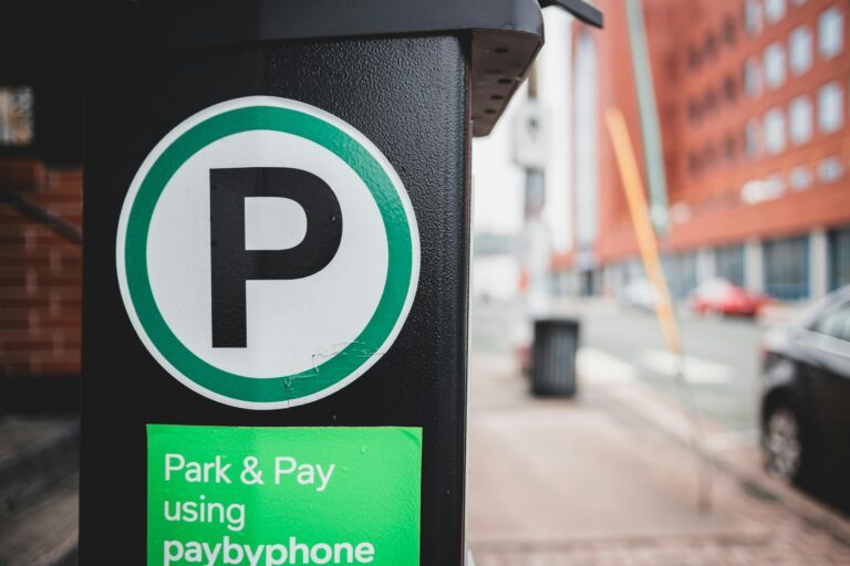 Photo of a parking metre with a sign that says park and pay using paybyphone.