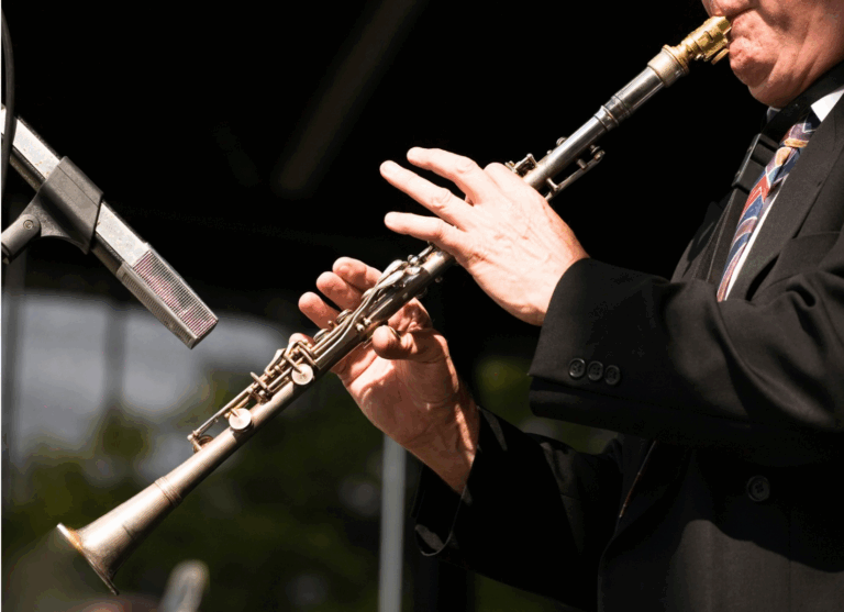 A person plays a woodwind instrument.