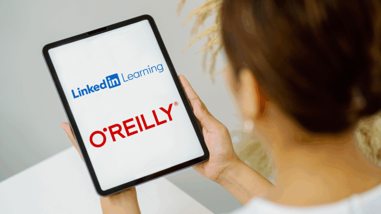 A woman holds a tablet displaying linkedIN Learning and O'Reilly
